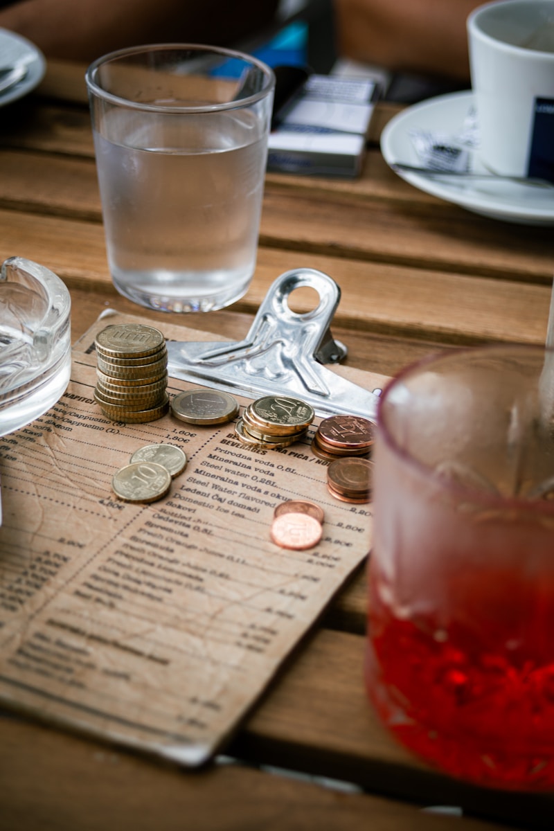 A wooden table topped with lots of coins
